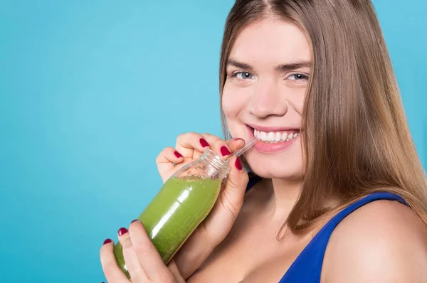 Primo piano della donna sorridente che beve bevanda verde — Foto Stock