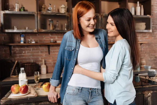 Positive delighted girls while embracing — Stock Photo, Image