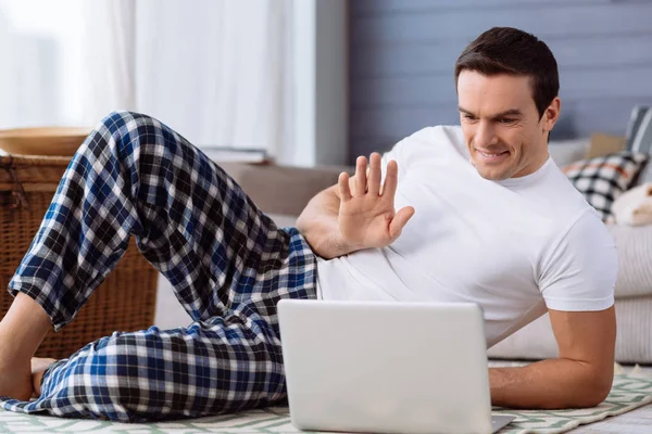 Positive delighted man making a video call