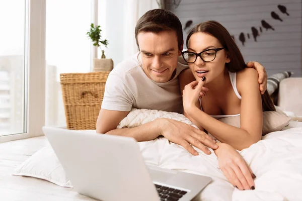Feliz pareja agradable mirando la pantalla del ordenador portátil —  Fotos de Stock
