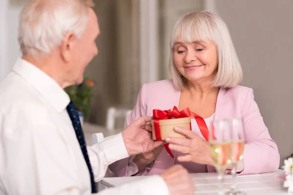 Delighted woman receiving gift — Stock Photo, Image