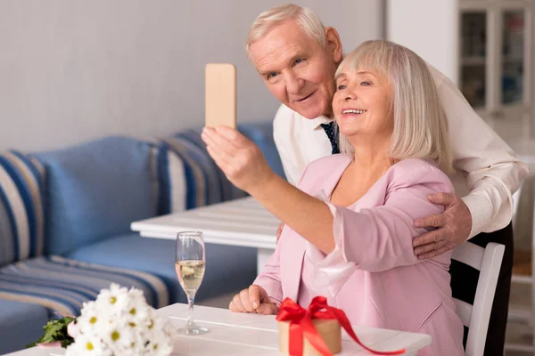 Admirable cute senior couple taking a selfie — Stock Photo, Image