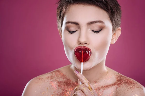 Overjoyed woman licking lollipop — Stock Photo, Image