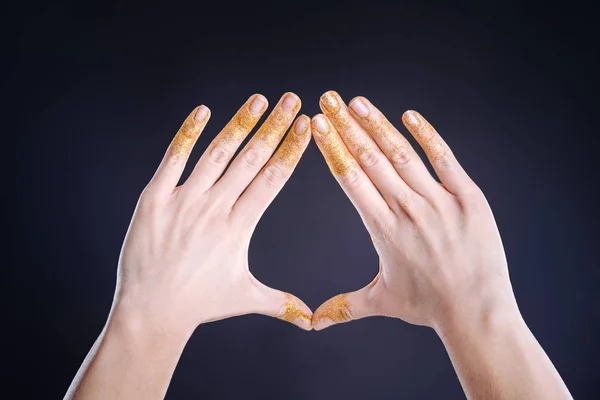 Close up of nice female hands gesturing against black background — Stock Photo, Image