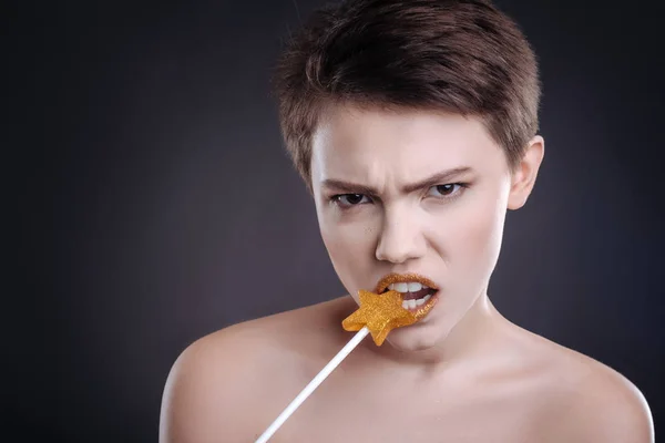 Beautiful emotional woman eating lollipop — Stock Photo, Image