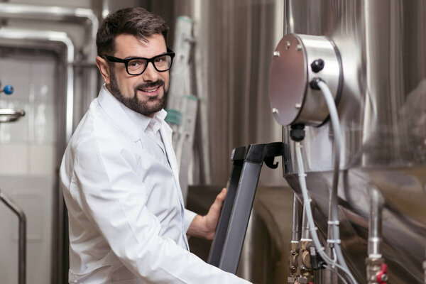 Joyful man posing with brewing machine