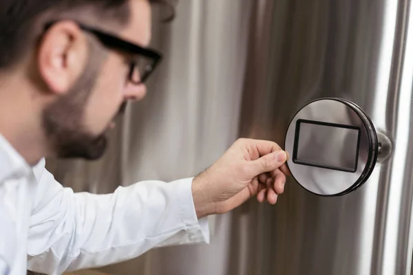 Serious man pressing a button on brewing mechanism — Stock Photo, Image