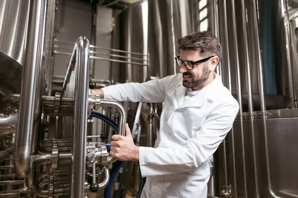 Delighted man using brewing mechanism — Stock Photo, Image