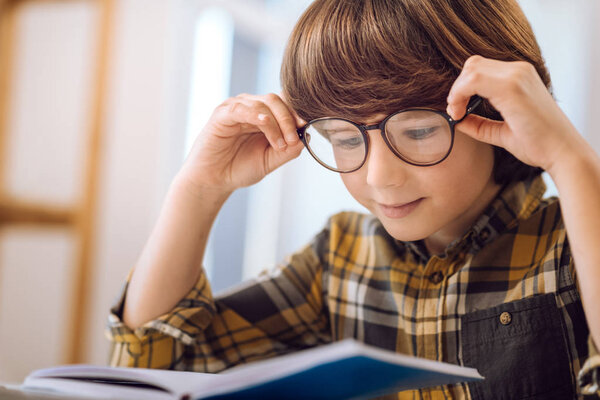 Kind child reading very attentively.