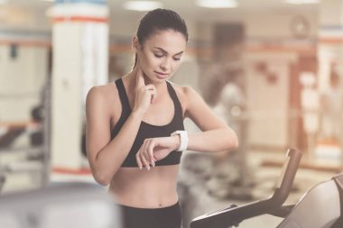 Konsantre kadın spor sonrası nabzını kontrol