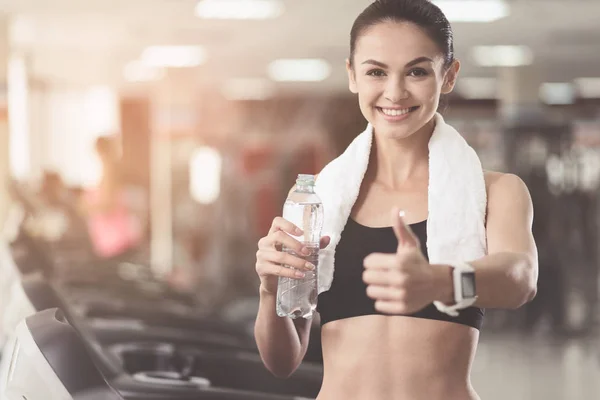 Vrolijke vrouw maken een goedkeuring gebaar in een sportschool — Stockfoto