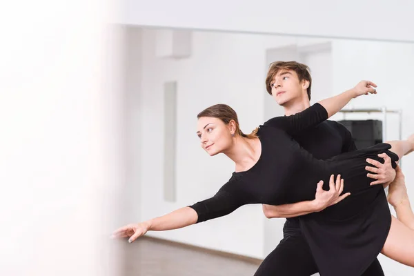 Mujer delgada positiva estar en manos de su pareja de baile — Foto de Stock