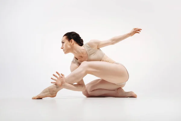 Muscular young athlete stretching — Stock Photo, Image