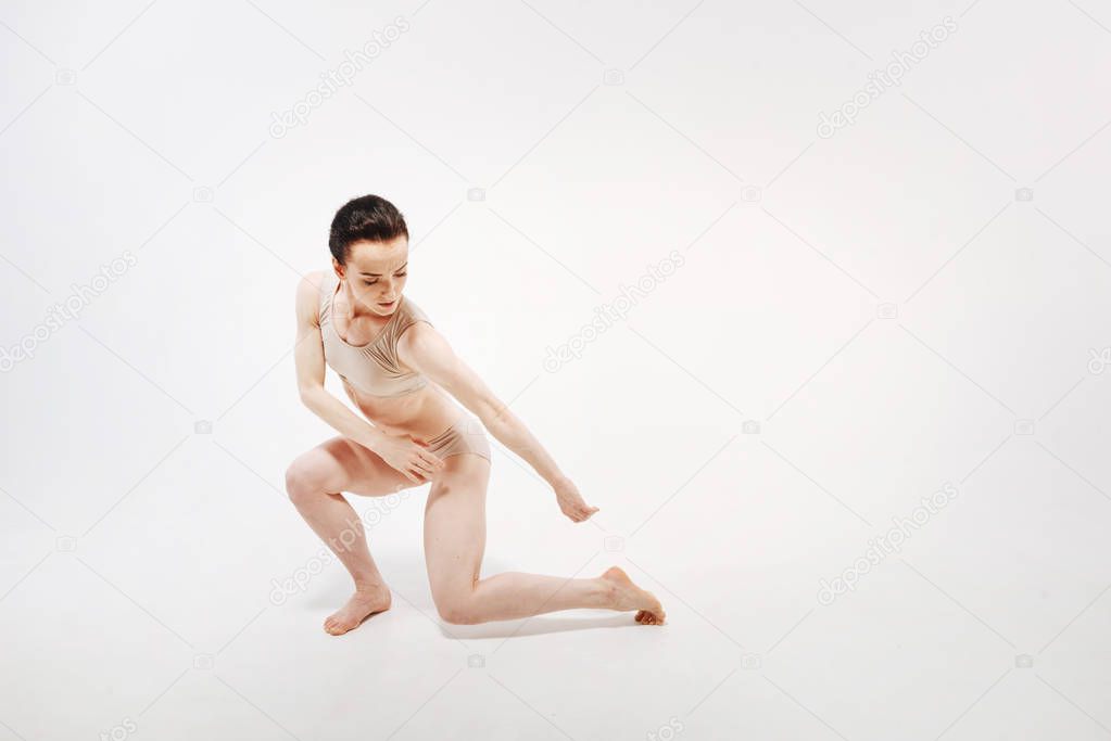 Concentrated young gymnast dancing 