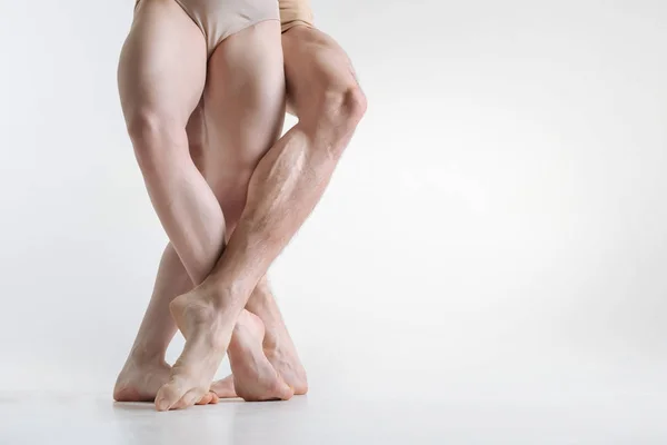 Athletic dancers legs located in the white colored room — Stock Photo, Image