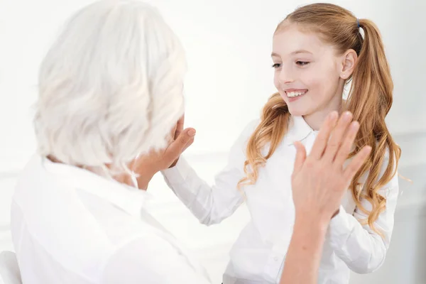 Positive little girl having rest with grandmother — Stock Photo, Image