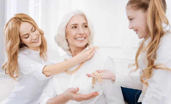 Positive female family members using accessories — Stock Photo, Image
