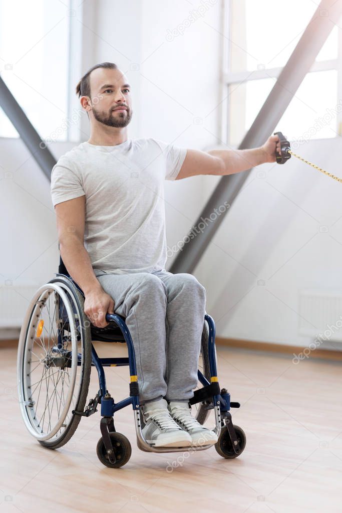 Powerful young handicapped individual working out in the gym