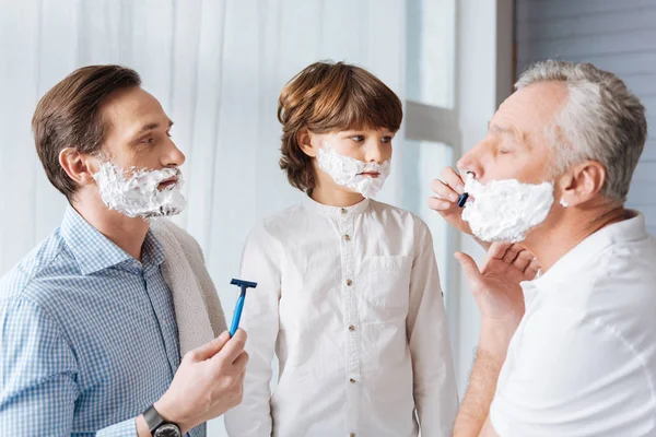 Pleasant aged man holding a razor — Stock Photo, Image