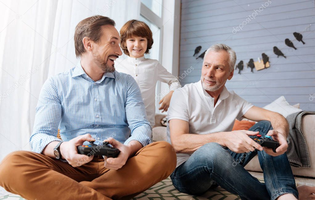 Happy delighted man holding a game console