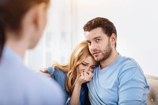 Depressief knappe man zijn vrouw knuffelen — Stockfoto