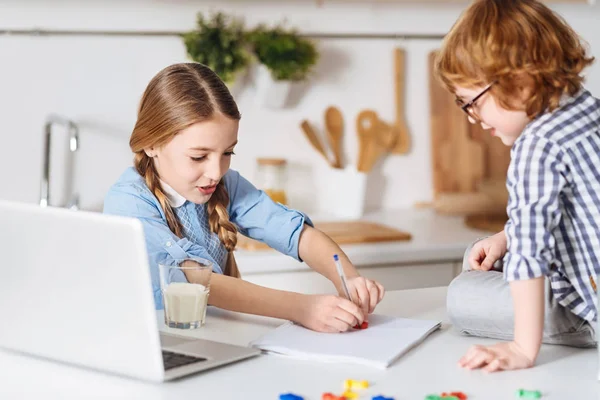 Clever determined girl teaching her sibling math — Stock Photo, Image