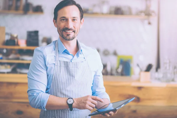 Cheerful cafe owner welcoming guests — Stock Photo, Image