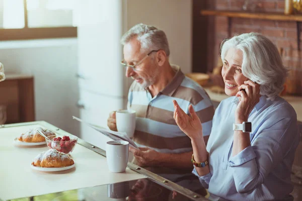 Positive aged couple having breakfast — Stock Photo, Image