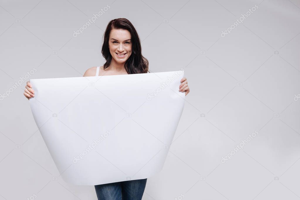 lady showing a big blank sheet of paper