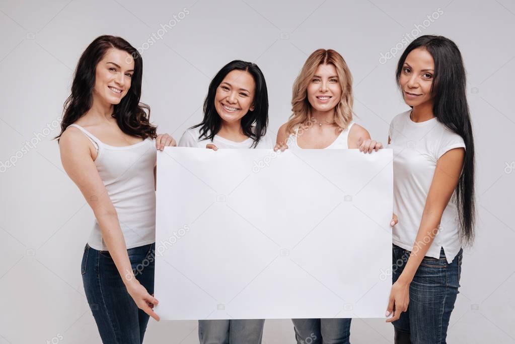 ladies demonstrating a big blank poster 
