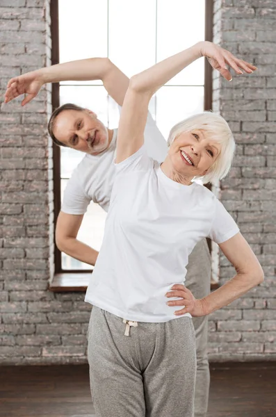 Vertical photo of happy couple while doing sport