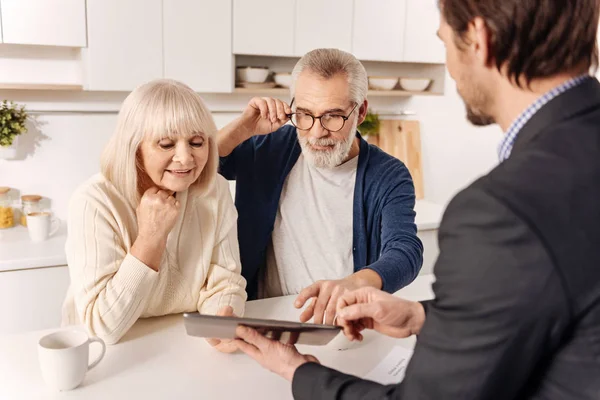 Couple using gadget with real estate agent — Stock Photo, Image