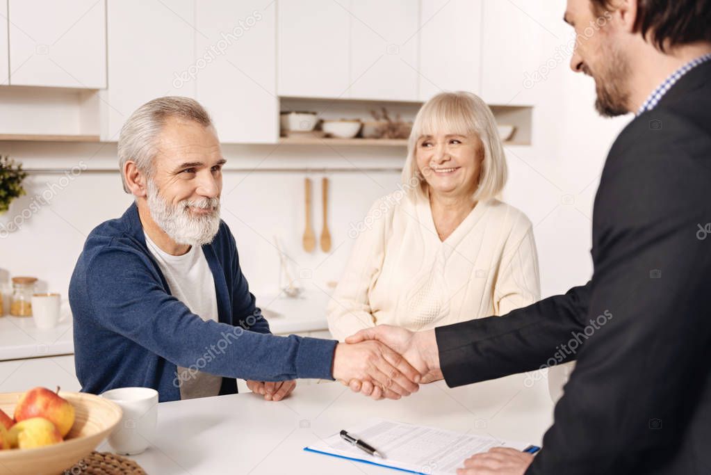 Successful broker meeting with elderly couple 