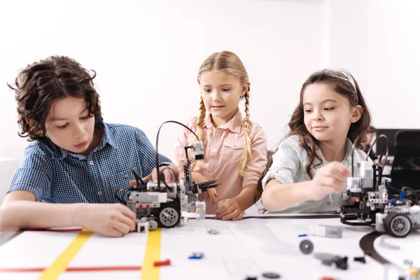 Joyful little friends working on the tech project — Stock Photo, Image