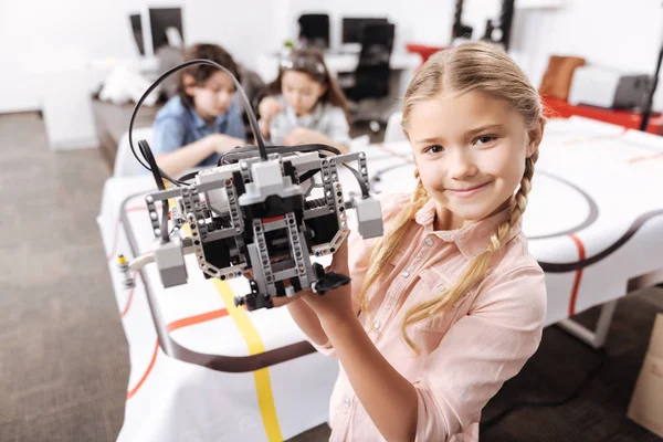 Cute little girl demonstrating robot — Stock Photo, Image