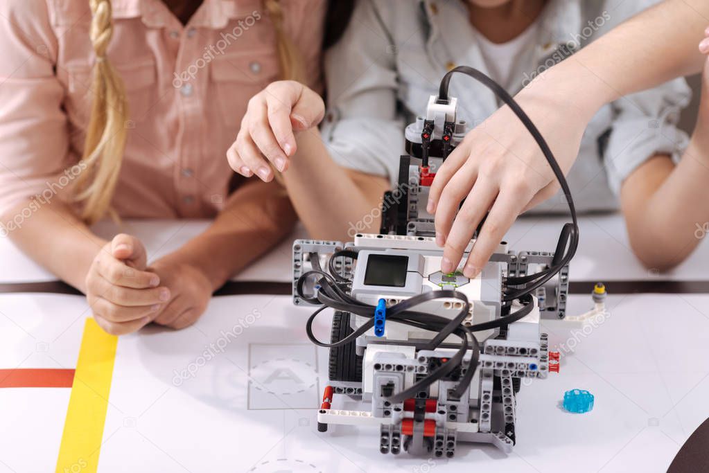 Skillful children testing robot at school