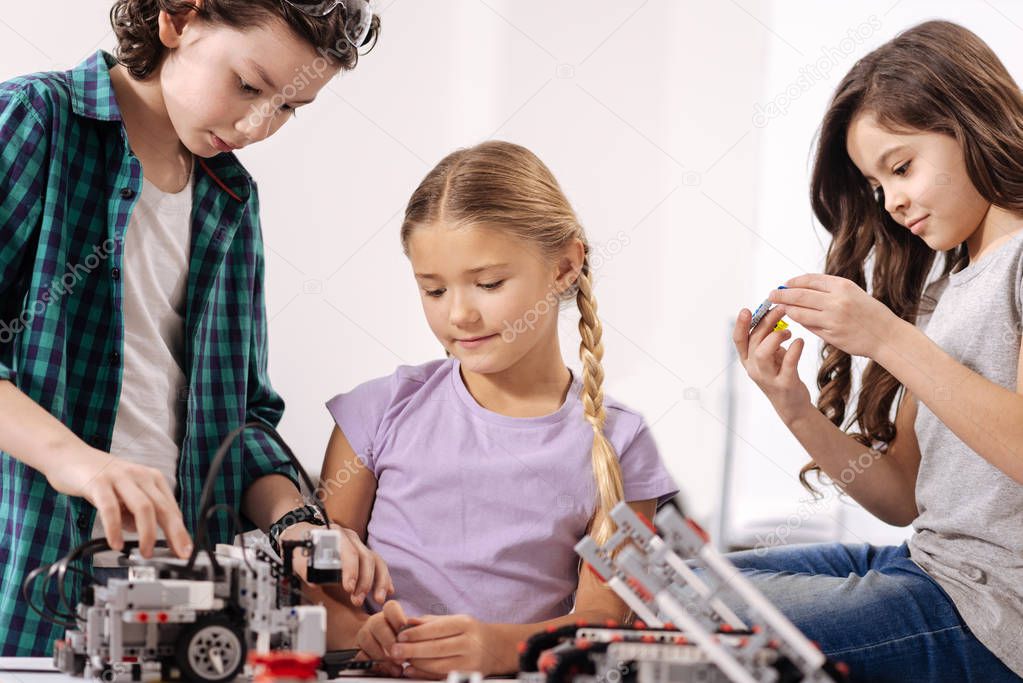 Inspired kids constructing robot at school