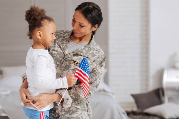 child and her mom holding little flags