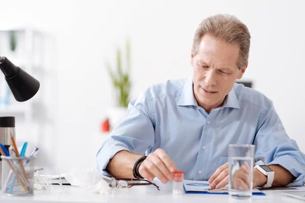 Delighted male person touching jar with tablets — Stock Photo, Image