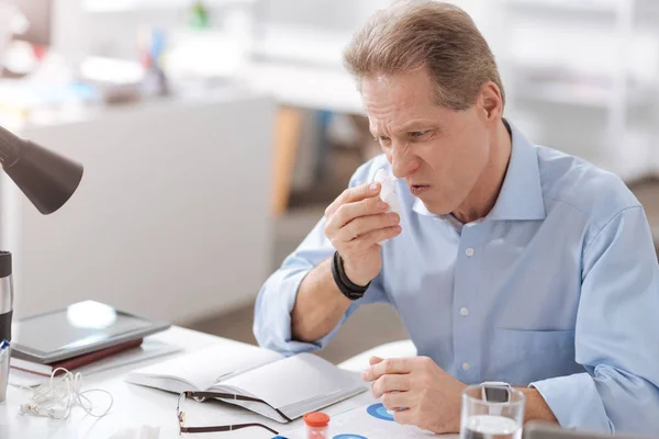 Negative delighted man wiping his nose — Stock Photo, Image