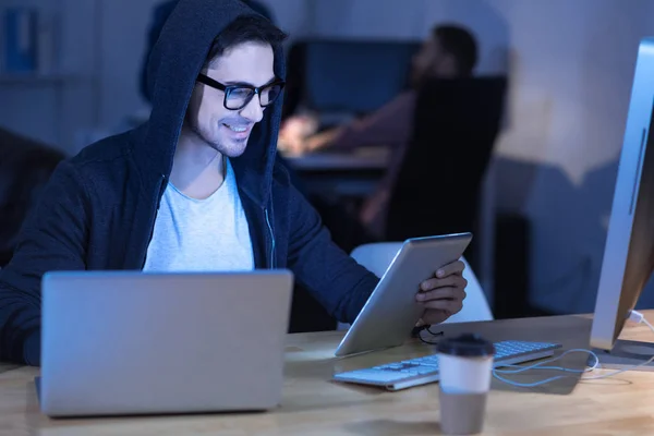 Delighted genius hacker being surrounded by modern technology — Stock Photo, Image