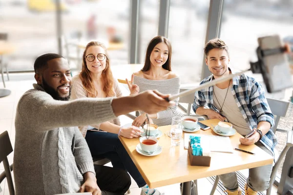 Bearded man taking selfies with friends — Stock Photo, Image