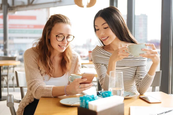 Cheerful friends sitting together in the cafe — Stock Photo, Image