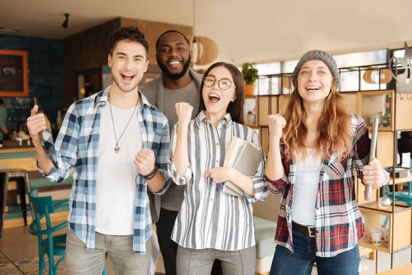 Lykkelige internasjonale studenter som uttrykker følelser – stockfoto