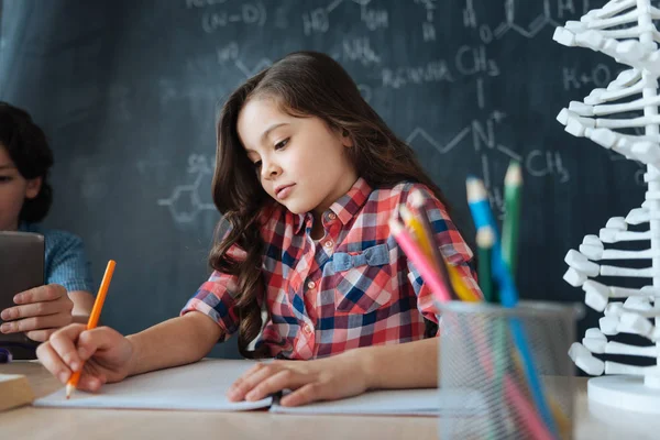 Involved little girl doing science homework — Stock Photo, Image