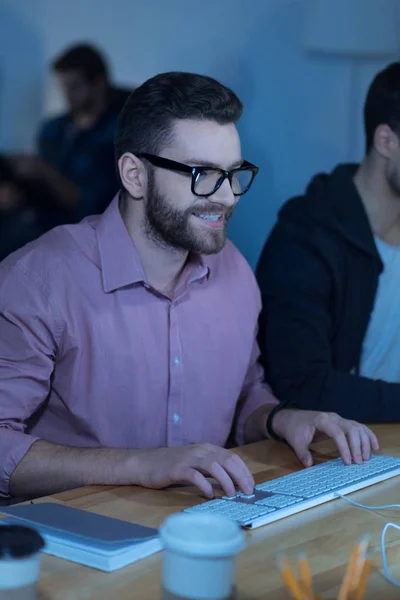 Nice delighted man typing on the keyboard — Stock Photo, Image
