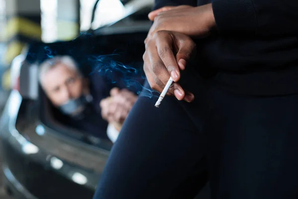Selective focus of a cigarette being smoked — Stock Photo, Image