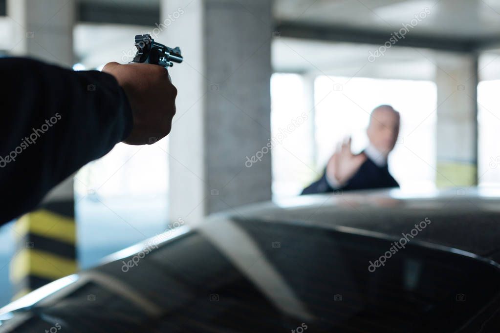 Handgun being targeted at a man
