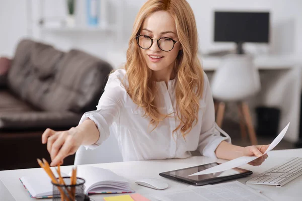 Creative young manager taking notes at the workplace — Stock Photo, Image