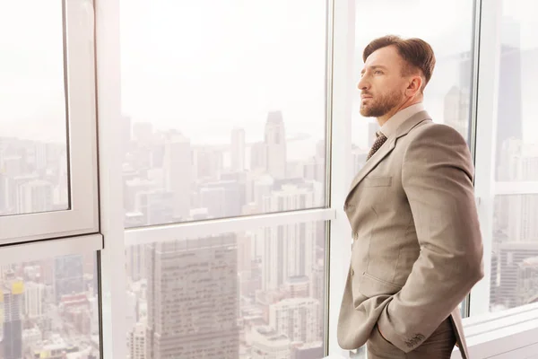 Businessman standing near window — Stock Photo, Image